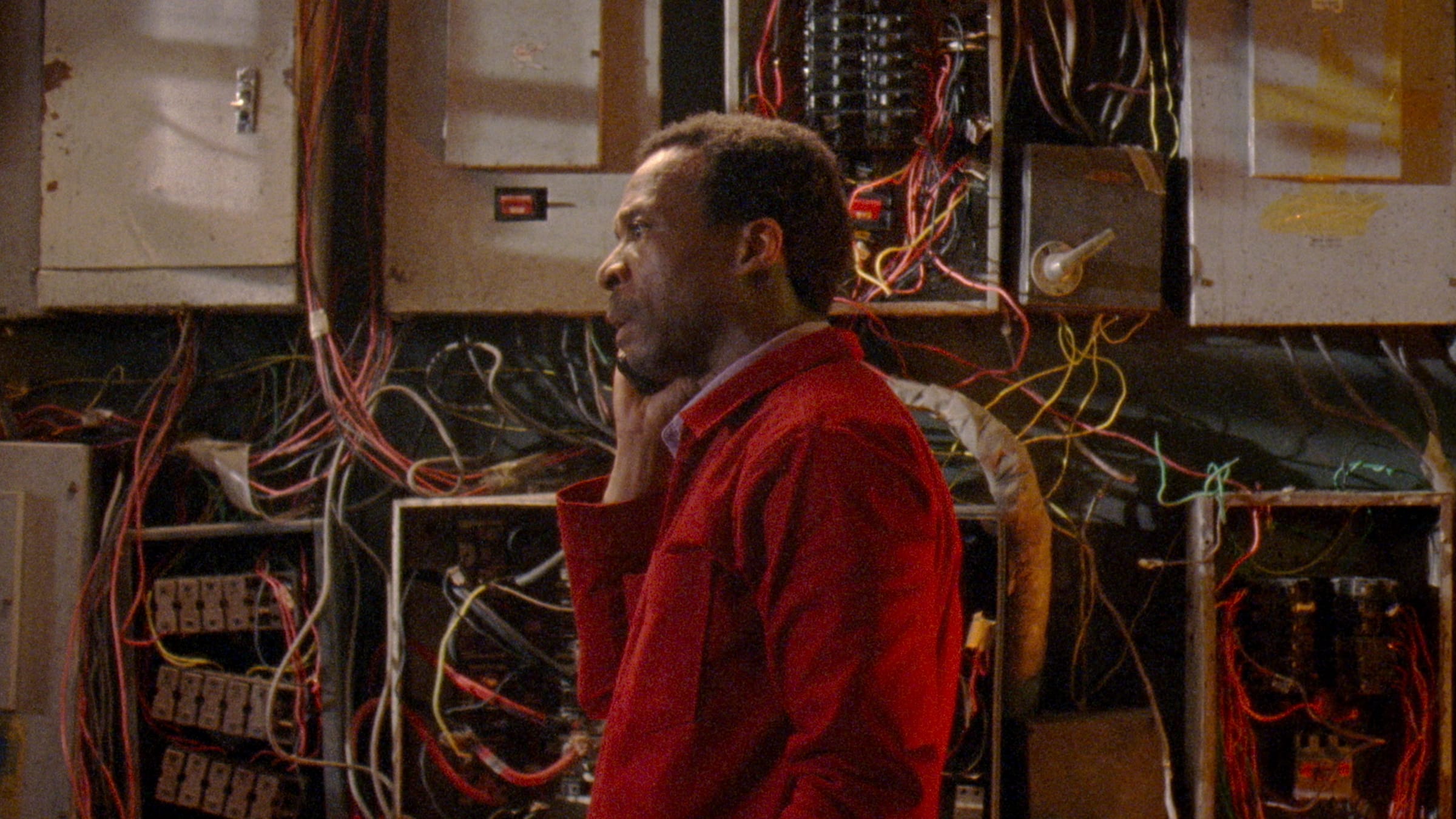 Electrical engineer in deep thought surrounded by wires